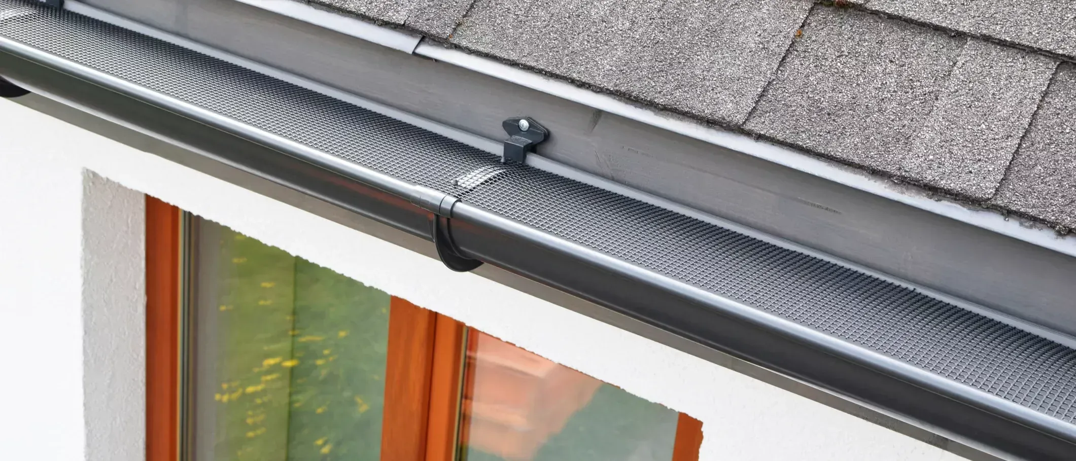 A fine mesh gutter guard fitted the length of a gutter run along the roof edge