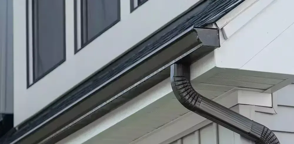 Sighting along a gutter run to the downspout, checking the water has somewhere to go
