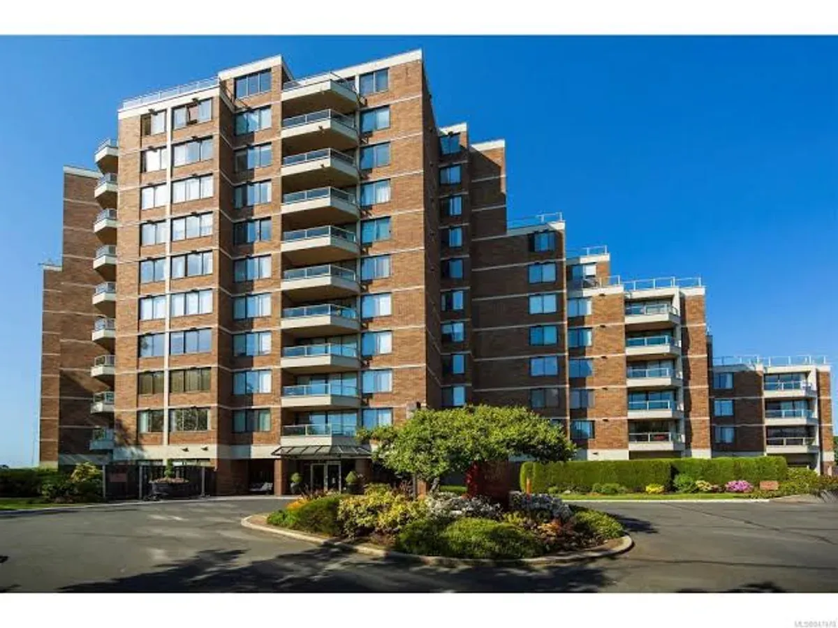 A multi-storey strata building with perimeter gutters and balconies